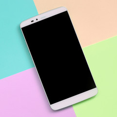Modern smartphone with black screen on texture background of fashion pastel pink, blue, coral and...