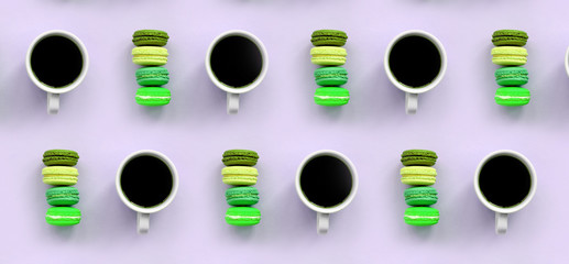A pattern of many colorful dessert cake macaroon and coffee cups on trendy pastel lilac background top view
