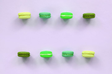 Dessert cake macaron or macaroon on trendy pastel lilac background top view