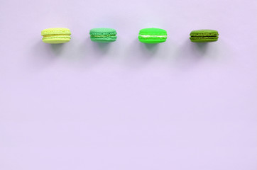 Dessert cake macaron or macaroon on trendy pastel lilac background top view