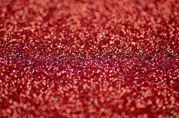 Crimson red decorative sequins. Background image with shiny bokeh lights from small elements