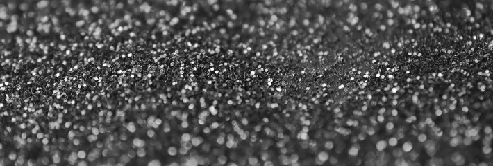 Silver decorative sequins. Background image with shiny bokeh lights from small elements