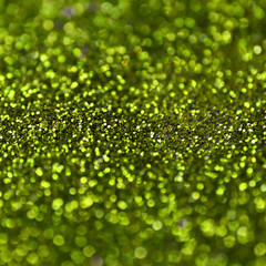 Lime green decorative sequins. Background image with shiny bokeh lights from small elements