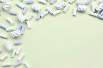 Colorful marshmallow laid out on lime paper background. pastel creative textured framework