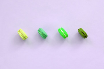 Dessert cake macaron or macaroon on trendy pastel lilac background top view