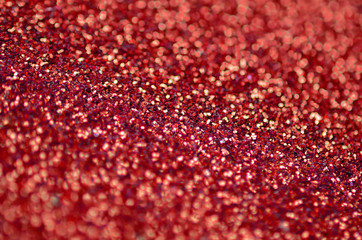 Crimson red decorative sequins. Background image with shiny bokeh lights from small elements