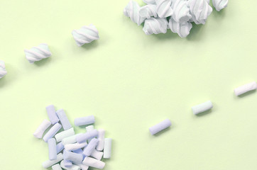 Colorful marshmallow laid out on lime paper background. pastel creative texture