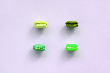 Dessert cake macaron or macaroon on trendy pastel lilac background top view