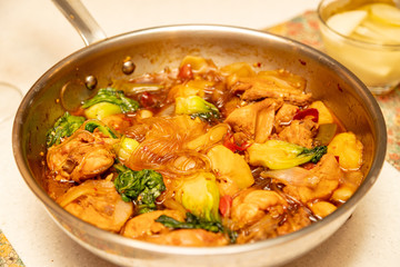 Spicy chicken stir-fry with sweet noodles.