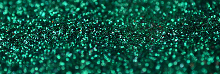 A huge amount of green decorative sequins. Background image with shiny bokeh lights from small...