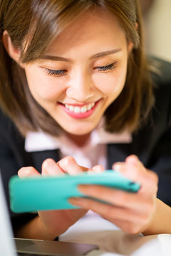 woman play mobile game happily