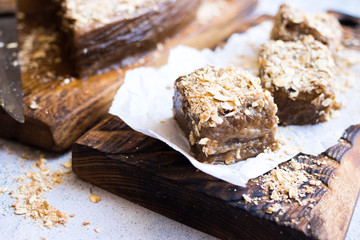Vegan chocolate cake oats, coconut on wooden board. Vegan