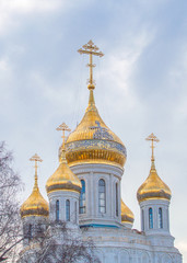 Fototapeta na wymiar Domes of christian Church of the New Martyrs and Confessors Russian on Lubyanka of Sretensky Monastery in Moscow, magnificent beauty of Russian orthodox architecture, golden domes with golden crosses