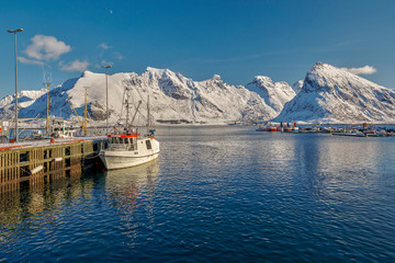 Traditional fishing boats in scenic harbor on Lofoten islands in Norway