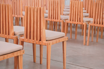 Wooden chairs in a row in a church.