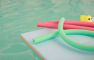 water aerobic equipment. colored aqua noodles in swimming pool