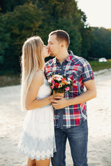 Couple in a park. Woman in a white dress. Man with his wife