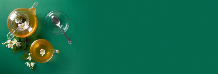 Fototapeta na wymiar jasmine tea on a green background. Top view. wide horizontal banner