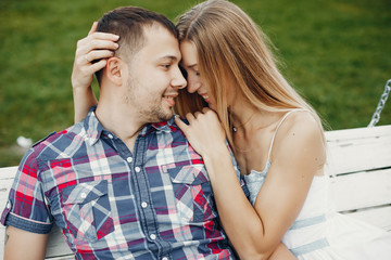 Couple in a park. Woman in a white dress. Man with his wife