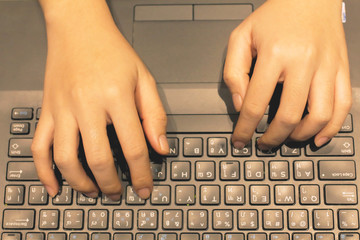 Employees are viewing information in the office in the shop for customers, women's hands.