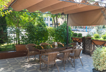 outdoor summer cafe with flower beds