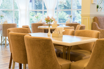 modern restaurant interior with windows and flowers. cafe room illuminated by sunlight