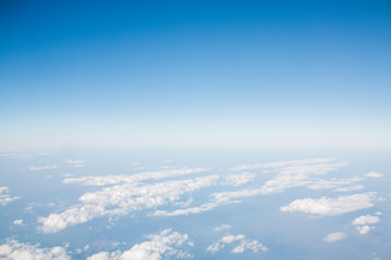Fototapeta na wymiar Blue sky with clouds background. View from airplane