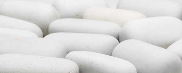 background of white smooth stones of elongated shape
