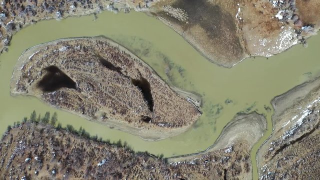 Video from a drone flying along valley of the Chuya river in Spring season. Altai, Siberia, Russia.