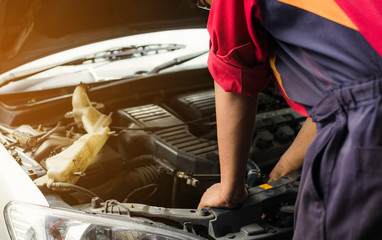 Auto mechanic checking and repairing car,Repairman working in garage station. Repair service.