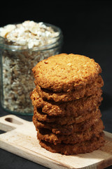 Homemade oatmeal cookie at dark background