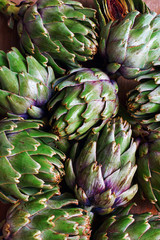 Closeup of fresh artichokes on wooden background
