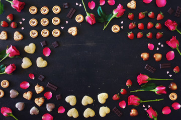 St Valentines or Mother's day frame with copy space. Heart shaped chocolate and cookies, red roses...
