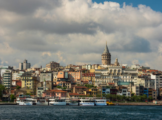 Beyoglu district old houses with Galata tower on top, view from the Golden Horn. June 26, 2019, Istanbul, Turkey 