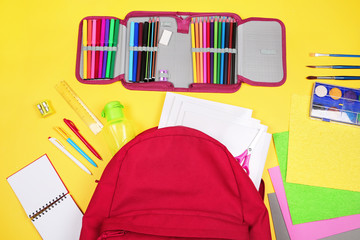 Different colorful School supplies on yellow background. Back to school sale, sopping concept