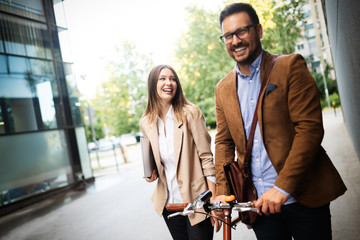 Portrait of happy smiling business people talking in the city
