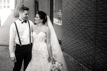 Bride and groom walking in the city, wedding day, marriage concept. Bride and groom in urban...