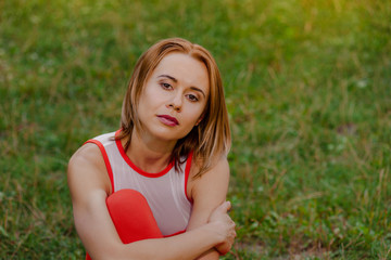 Portrait of beautiful smiling yoga woman resting after training