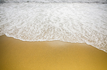 Beautiful sea coast. Waves with foam. Summer travel concept. Sand with buoy in water.