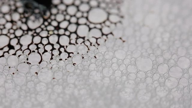 black liquid moving through bubbles like an alien organism.