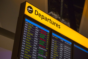 Departure board displaying flight information at London Heathrow airport