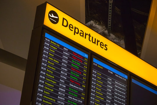 Departure Board Displaying Flight Information At London Heathrow Airport