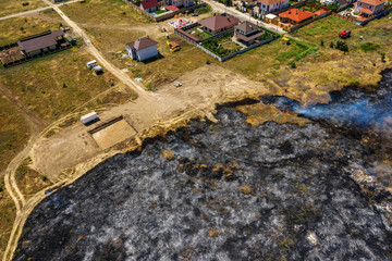 Heavy smoke in steppe. Forest and steppe fires destroy field, steppes during severe droughts. Fire, strong smoke. Blur focus due to shaking hot fire. Disaster, damage, risk to homes. View from drone