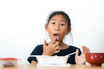 Asian girl eating spaghetti food box from convenient store, modern lifestyle concept.