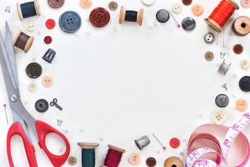 flat composition with scissors and sewing supplies on white background. Space for text