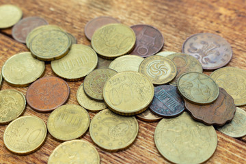coins old rusty brass euro pile pack heap stack on a wooden background finance economy investment savings concept mock up selective focus close up