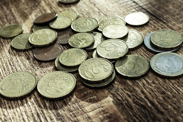 coins old rusty brass euro pile pack heap stack on a wooden background finance economy investment savings concept mock up selective focus close up