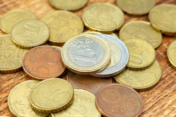 coins old rusty brass euro pile pack heap stack on a wooden background finance economy investment savings concept mock up selective focus close up