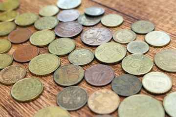coins old rusty brass euro pile pack heap stack on a wooden background finance economy investment savings concept mock up selective focus close up