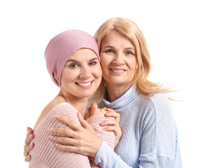 Woman after chemotherapy with her mother on white background